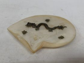 A CHINESE EXPORT SILVER DRAGON RELIEF DISH, MOUNTED ON A MOTHER OF PEARL SHELL, 18CM X 14CM