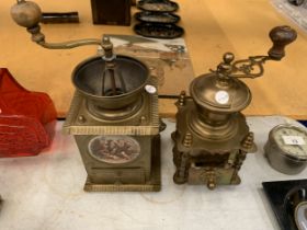 TWO VINTAGE BRASS COFFEE GRINDERS, ONE WITH A CERAMIC PLAQUE TO THE FRONT