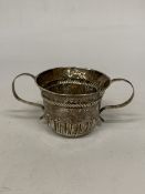 A SILVER TWIN HANDLED CUP WITH REPOUSSE DECORATION - WEIGHT 59.34 G