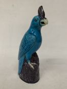 A VINTAGE CHINESE PORCELAIN PARROT FIGURE, WITH A TURQUOISE GLAZED BODY AND AUBERGINE COLOURED CREST