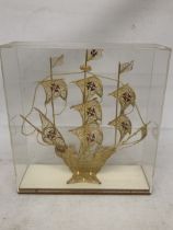 A MODEL OF A GILT GALLEON WITH ENAMEL FLAGS IN A CASE, HEIGHT 33CM, WIDTH 30CM, DEPTH 10CM