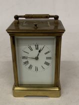 A FRENCH BRASS CARRIAGE CLOCK WITH GLASS ESCAPEMENT (ONE PANE MISSING)