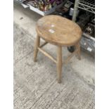 A VINTAGE PINE FOUR LEGGED STOOL
