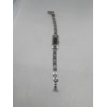 A VINTAGE GUCCI 3900L STAINLESS STEEL TANK WATCH WITH TWENTY FOUR DIAMONDS FLANKING THE DIAL (