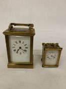 AN ANTIQUE BRASS CARRIAGE CLOCK HOUSED IN A GILT-BRASS CASE WITH BEVELLED GLASS PANELS TOGETHER WITH
