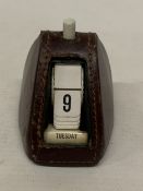 A VINTAGE PERPETUAL CALENDAR WITH A LEATHER CASING