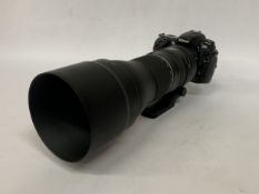 A NIKON D300 DSLR CAMERA WITH A TAMRON 150mm-600mm TELEPHOTO LENS WITH LENS CAP