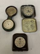 A VINTAGE SPIRIT OF ST. LOUIS QUARTZ TRAVEL ALARM CLOCK IN A METAL CLAMSHELL CASE TOGETHER WITH A