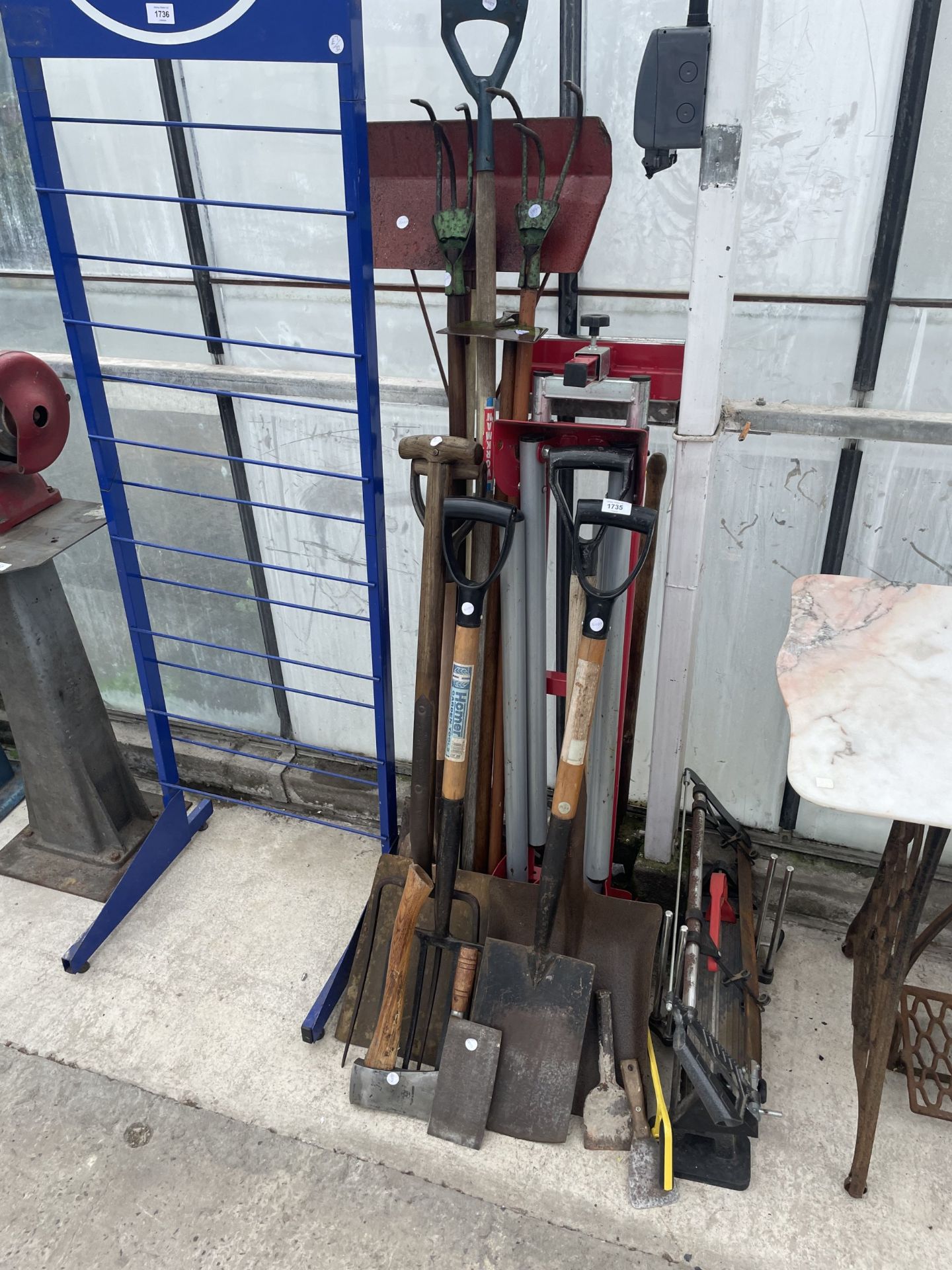 AN ASSORTMENT OF VARIOUS TOOLS TO INCLUDE SPADES, FORKS, TROWELS AND A MITRE SAW ETC
