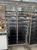 A MOBILE TRAY RACK WITH TRAYS