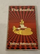 A 1968 FIRST EDITION PAPERBACK OF THE BEATLES YELLOW SUBMARINE PUBLISHED BY THE NEW ENGLISH LIBRARY