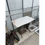 A VINTAGE SINGER TREADLE SEWING MACHINE BASE WITH MARBLE EFFECT TOP