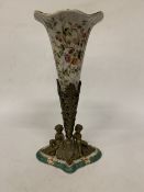 A WONG-LEE 1895 PORCELAIN CORNUCOPIA VASE WITH A BRONZED BASE DEPICTING CHERUBS