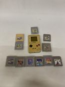 A VINTAGE HANDHELD NINTENDO GAME BOY CONSOLE TOGETHER WITH ELEVEN GAMES TO INCLUDE SUPER MARIO LAND,