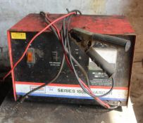 A METAL FILING CABINET AND SERIES 1000 CHARGER NO VAT
