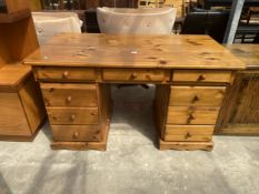 A PINE TWIN PEDESTAL DESK ENCLOSING EIGHT DRAWERS, 56" X 30"