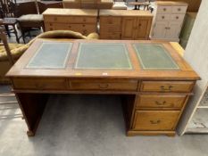 AN OAK PEDESTAL DESK WITH INSET LEATHER TOP, FOUR DRAWERS AND ONE SHAM DRAWER, 60" X 30"