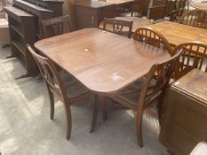 A REGENCY STYLE MAHOGANY DROP LEAF PEDESTAL DINING TABLE AND FOUR CHAIRS