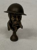 A BRONZE 'OLD BILL PIPE TAMPER