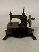 AN ANTIQUE GERMAN CHILD'S TOY SEWING MACHINE
