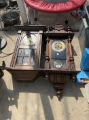 AN OAK CASED CHIMING WALL CLOCK AND A MAHOGANY CASED CHIMING WALL CLOCK