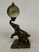 AN OMEGA BUBBLE CLOCK ON A COPPER AND ZINC ELEPHANT BASE, HEIGHT 23CM