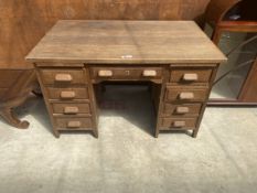 A MID 20TH CENTURY OAK TWIN PEDESTAL DESK ENCLOSING EIGHT DRAWERS AND TWO SLIDES, 48" X 30"