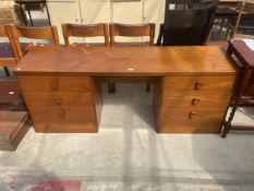 A RETRO TEAK TWIN PEDESTAL DRESSING TABLE ENCLOSING SIX DRAWERS, 64" WIDE