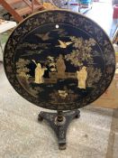 A CHINESE EXPORT GILT AND BLACK LACQUER TILT-TOP TABLE WITH GILT SCENES OF FIGURES IN A LANDSCAPE