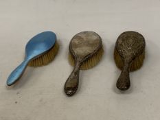 THREE HALLMARKED SILVER HAIR BRUSHES, ONE CHESTER, ONE LONDON AND ONE WITH ENGINE TURNED ENAMEL