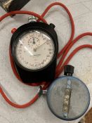 A VINTAGE ADMISSION COUNTER TOGETHER WITH A STOPWATCH