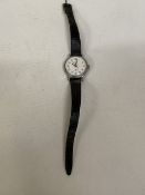 A LADIES TIMEX WATCH WITH A BLACK LEATHER STRAP - WORKING AT TIME OF CATALOGUING BUT NO WARRANTIES