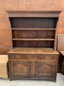 A GEORGE III OAK DRESSER WITH PLATE RACK, TWO DRAWERS AND TWO CUPBOARDS TO BASE, 56" WIDE