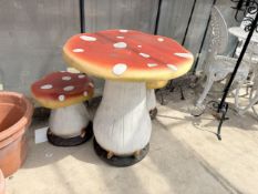 A PLASTER TOAD STOOL TABLE AND TWO MATCHING STOOLS