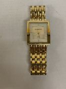 A LADIES DIAMOND & CO WATCH WITH A SQUARE FACE AND GOLD TONE STRAP - WORKING AT TIME OF CATALOGUING,