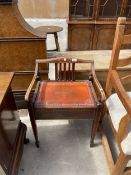 AN EDWARDIAN MAHOGANY AND INLAID PIANO STOOL WITH RAISED BACK AND SCROLL ARMS