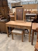 AN OAK DRESSING TABLE WITH SWING FRAME MIRROR, THREE DRAWERS AND MATCHING STOOL