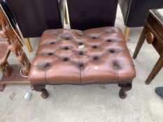 A LEATHER BUTTONED FOOT STOOL ON CABRIOLE LEGS