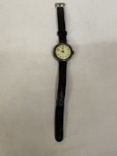 A GENTLEMAN'S SILVER CASED WWI TRENCH WATCH WITH LEATHER STRAP - WORKING AT TIME OF CATALOGUING,