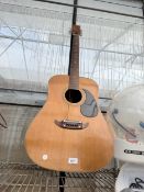 AN ACOUSTIC GUITAR (REQUIRES RE STRINGING)