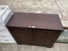 AN OAK DRESSER BASE ENCLOSING TWO DRAWERS AND TWO CUPBOARDS, 36" WIDE