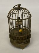 A SMALL BRASS BIRD CAGE CLOCK