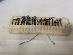A COLLECTION OF 34 LACE MAKING BOBBINS, MANY WITH ENAMEL DECORATION, CHARMS AND SPANGLES IN A