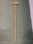 A WOODEN WALKING STICK WITH NORDIC REINDEER DESIGN AND ICE PICK STYLE HANDLE