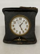 A VINTAGE FOLDING LEATHER-CASED BELIEVED TO BE SWISS MADE 8 DAY MOVEMENT MEDHANICAL TRAVEL CLOCK