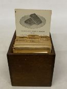 A CIRCA 1920'S SET OF COMMERCIAL BAKERY RECIPE CARDS IN AN OAK CASE