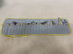 A COLLECTION (APPROX 36) OF BONE LACE MAKING BOBBINS WITH CHARMS AND SPANGLES IN A POUCH