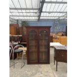 A VICTORIAN MAHOGANY BOOKCASE WITH TWO ARCHED GLAZED DOORS 44" WIDE