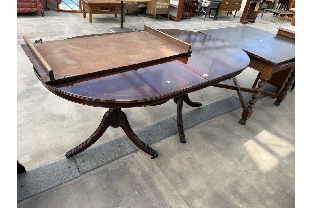 A REGENCY STYLE MAHOGANY TWIN PEDESTAL DINING TABLE 64" X 40" (LEAF 22") - Image 1 of 3