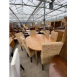 AN OVAL RETRO TEAK EXTENDING DINING TABLE AND FOUR WICKER DINING CHAIRS